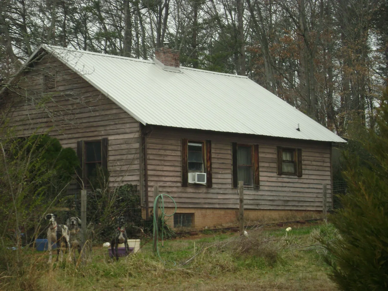 White metal roof on an old wood sided farmhouse, from a Asphalt Shingle Roof Repair job in Lewiston